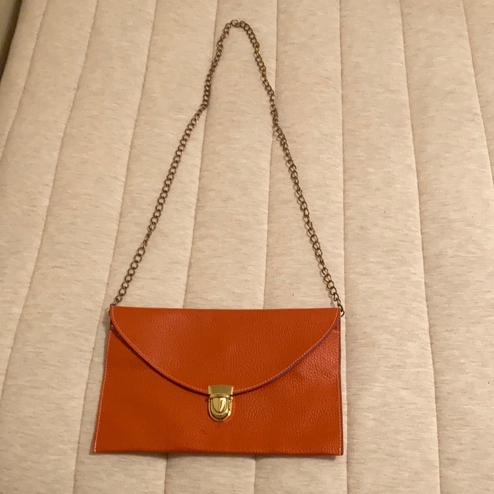 Orange clutch with removable chain strap